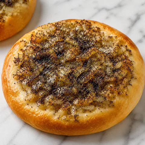 Cebularz, a round yeast flatbread topped with soft onion and poppy seeds